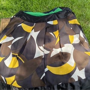 Flowy skirt with browns, blacks, whites and yellows.